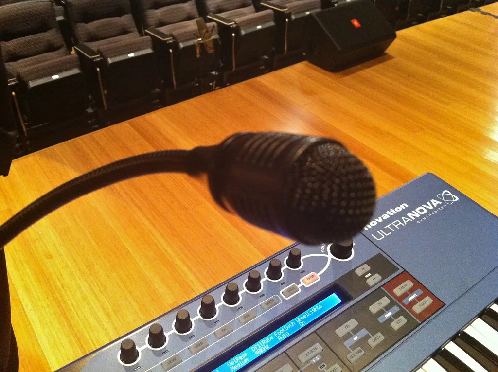 Electronic synthesizer and microphone on stage Electronic synthesizer and microphone on stage