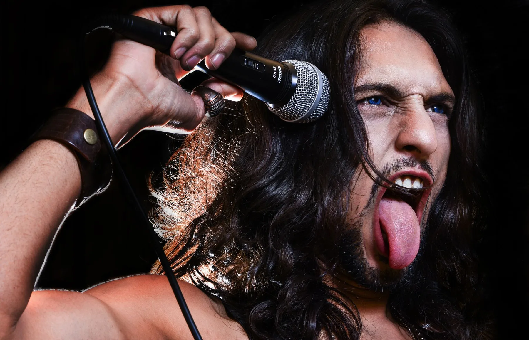Rock singer holding his microphone Rock singer holding his microphone