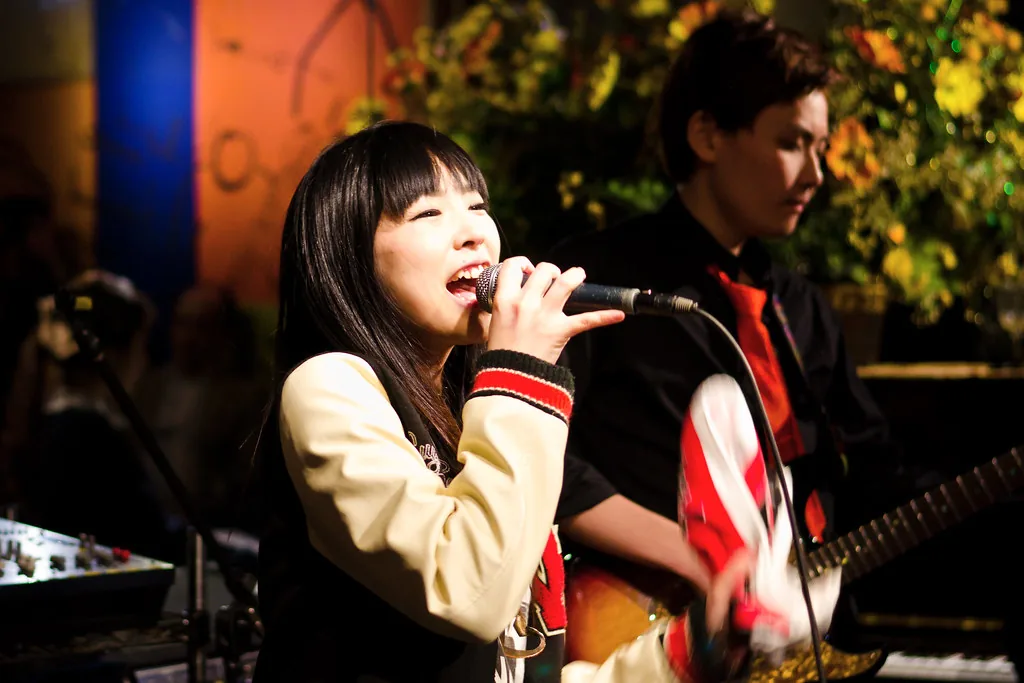 Female rock singer performing in concert with a band Female rock singer performing in concert with a band