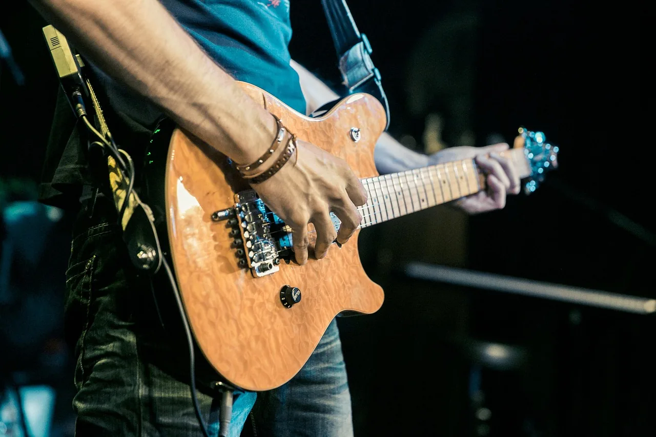 Guitarist performing onstage in concert Guitarist performing onstage in concert