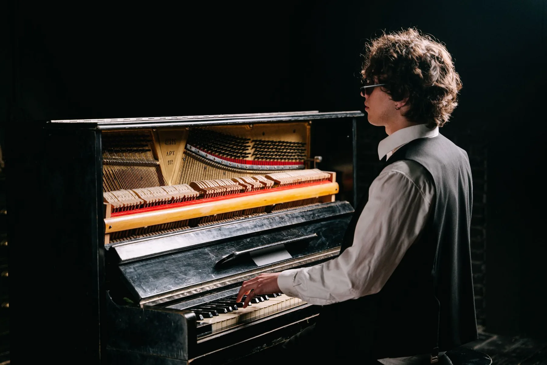 Musician playing an antique piano Musician playing an antique piano