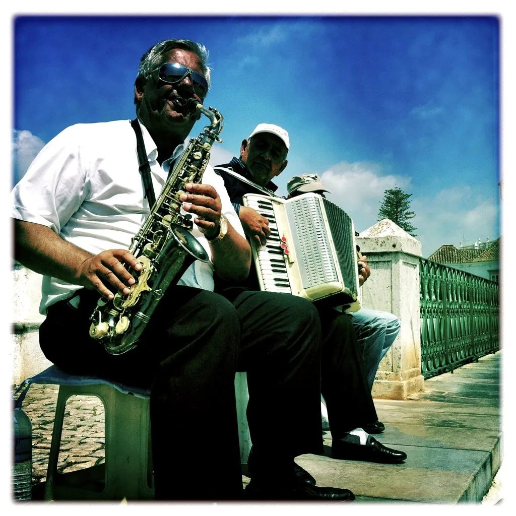 Street musicians playing saxophone and accordion Street musicians playing saxophone and accordion